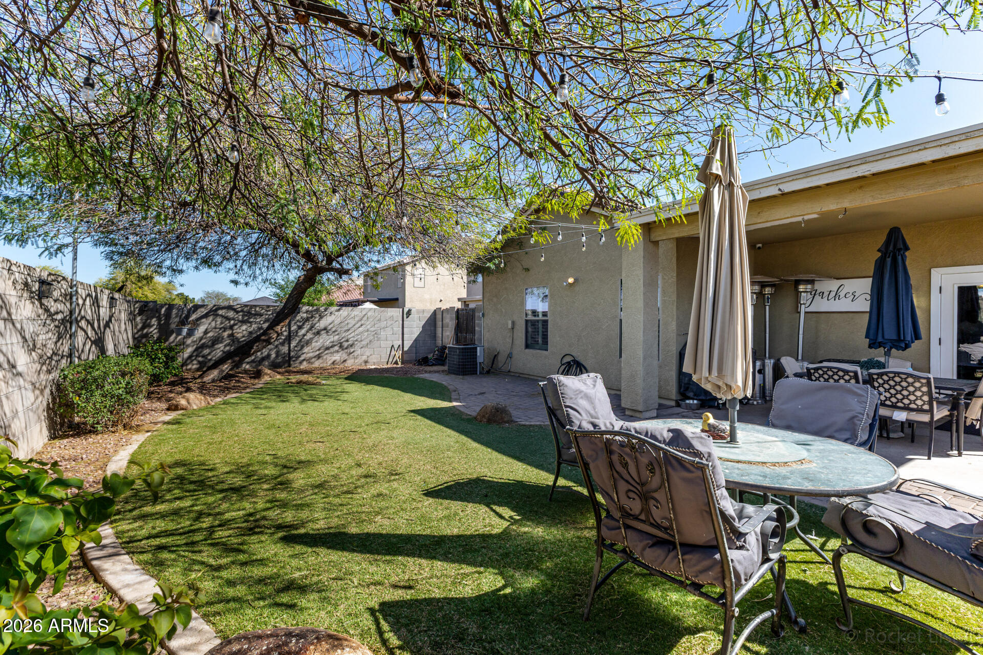 9646 West Payson Road Tolleson, AZ 85353 - Photo 33 of 36 a view of an chairs and table in the backyard