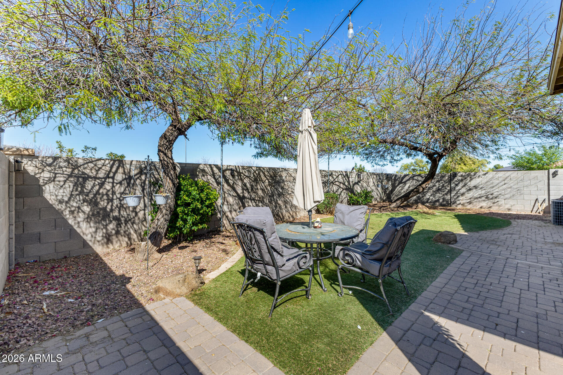 9646 West Payson Road Tolleson, AZ 85353 - Photo 34 of 36 a view of a backyard with table and chairs and a fire pit
