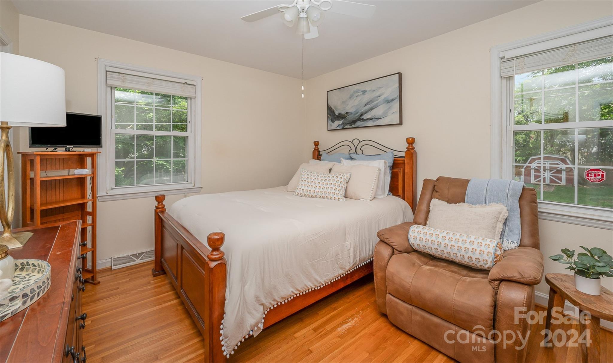 3117 Pendleton Avenue Charlotte, NC 28210 - Photo 16 of 25 a bedroom with a bed a couch and large window