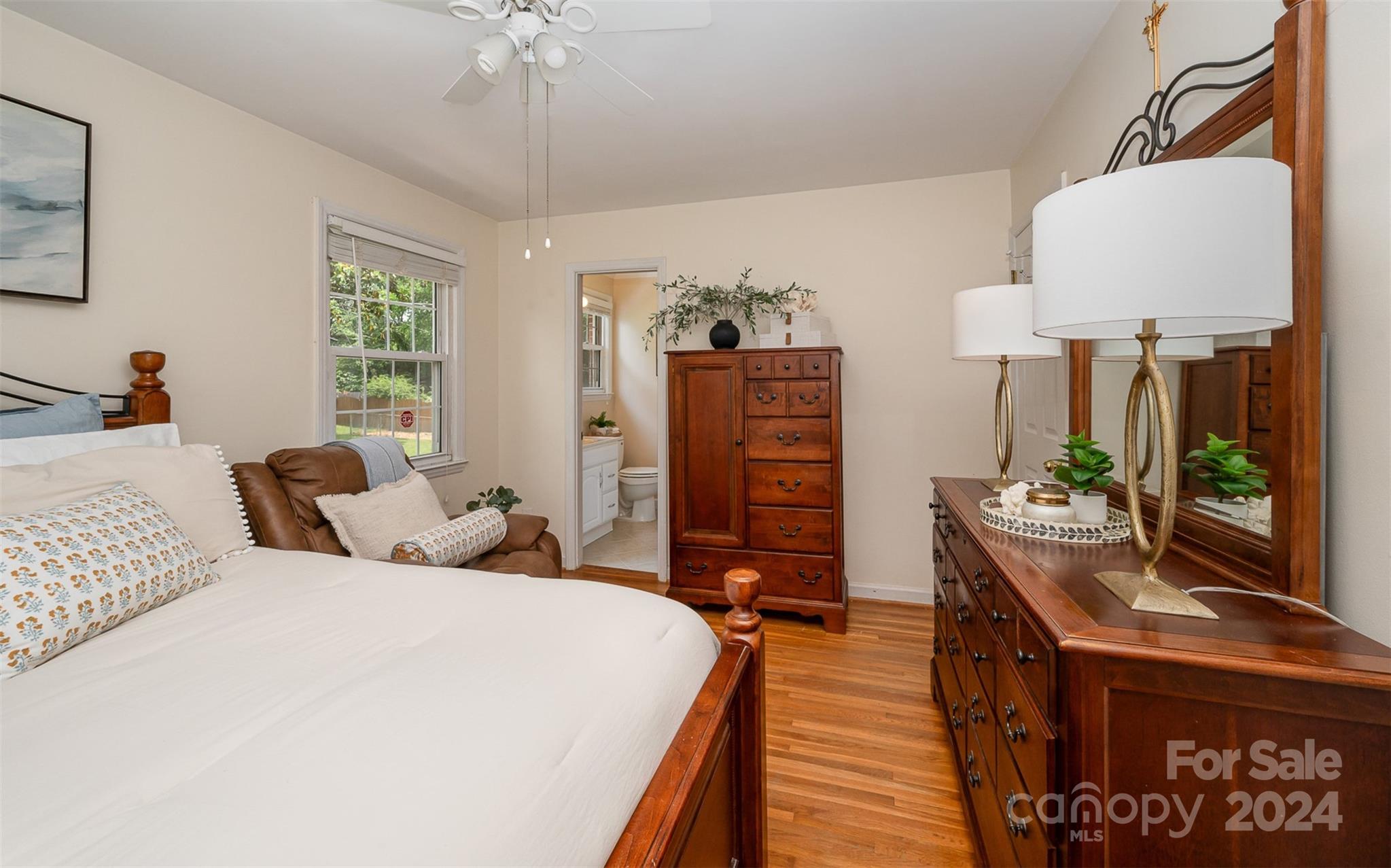 3117 Pendleton Avenue Charlotte, NC 28210 - Photo 17 of 25 a bedroom with a bed and a chandelier