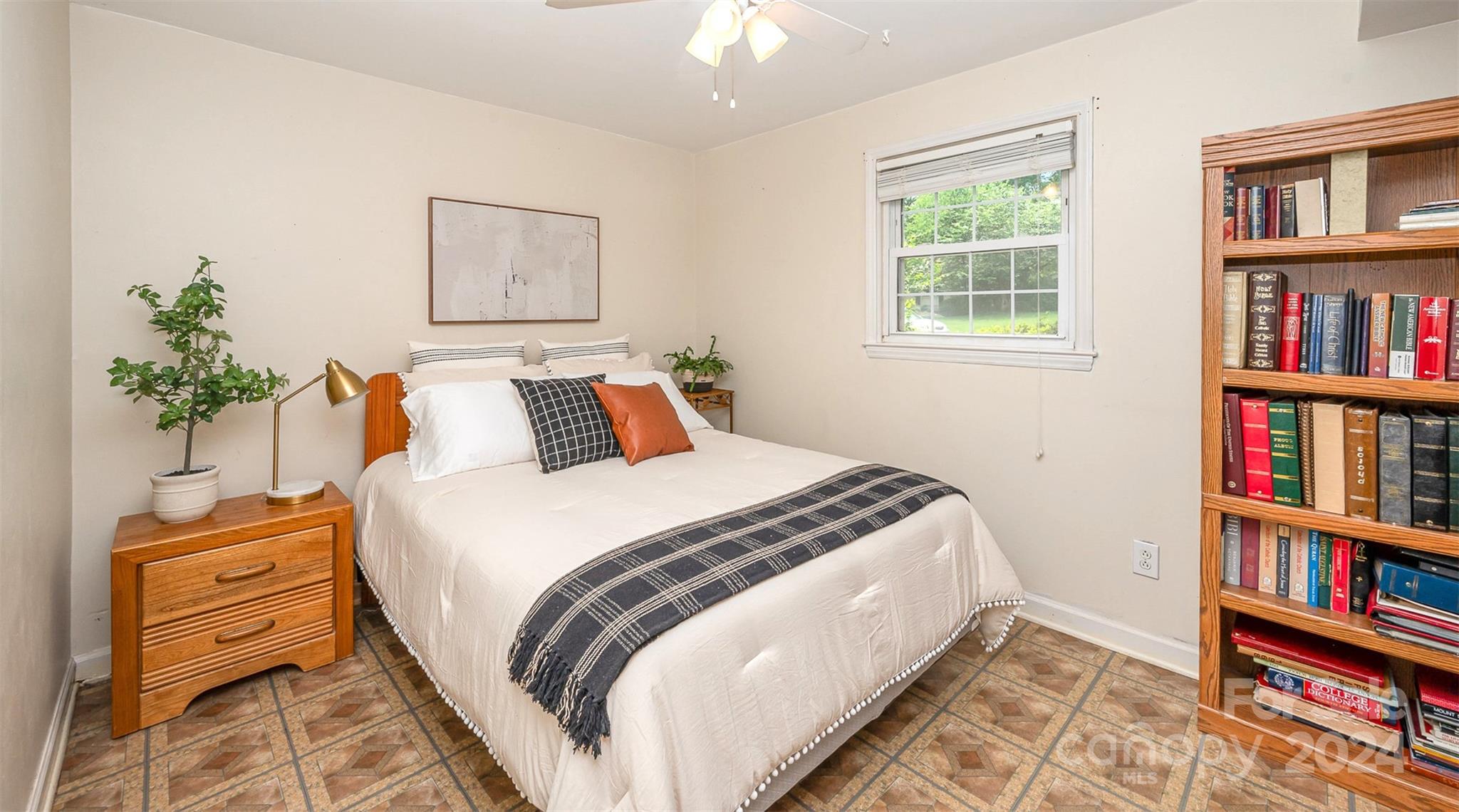 3117 Pendleton Avenue Charlotte, NC 28210 - Photo 22 of 25 a bedroom with bed and a book shelf