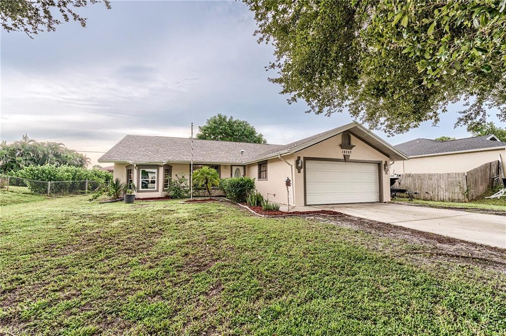 18257 Huckleberry Road Fort Myers, FL 33967 - Photo 1 of 18 a front view of a house with a yard and garage