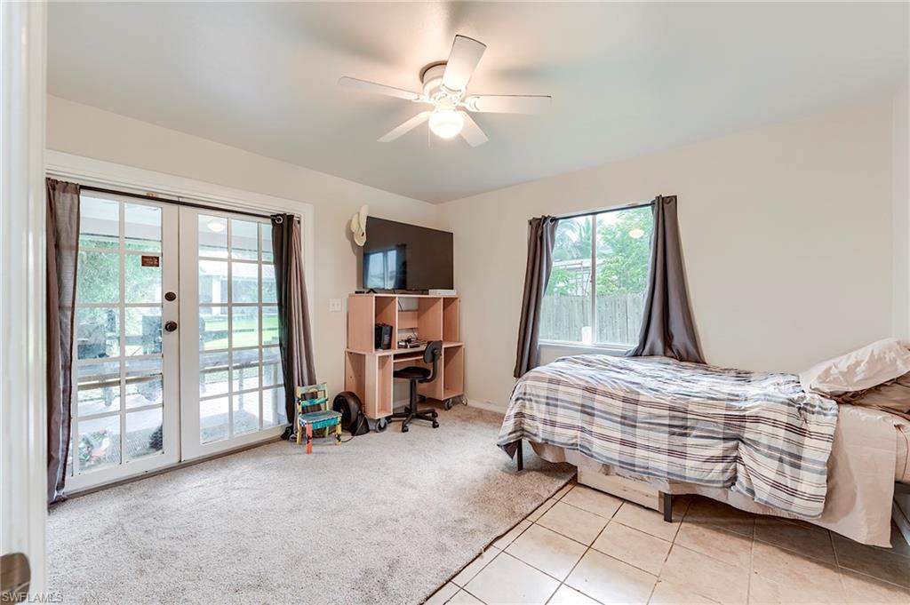 18257 Huckleberry Road Fort Myers, FL 33967 - Photo 11 of 18 a bedroom with bed and a large window with the outer view