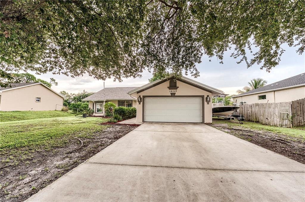 18257 Huckleberry Road Fort Myers, FL 33967 - Photo 18 of 18 a view of a house with a yard and large tree