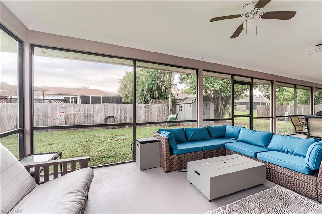 18257 Huckleberry Road Fort Myers, FL 33967 - Photo 2 of 18 a living room with furniture and a floor to ceiling window