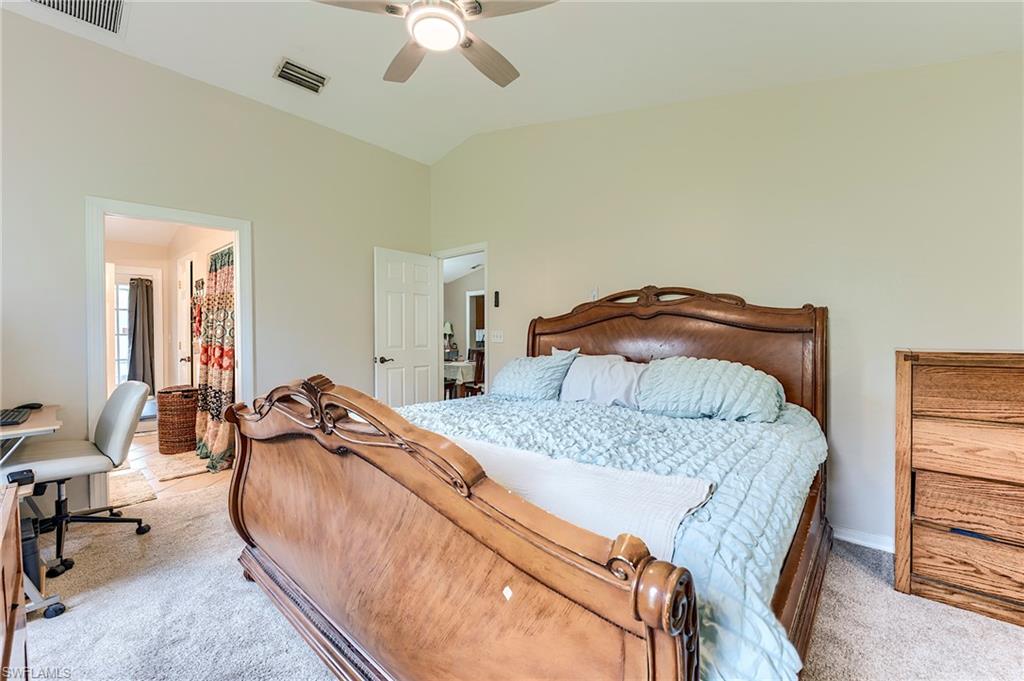 18257 Huckleberry Road Fort Myers, FL 33967 - Photo 9 of 18 a bedroom with a bed a chair and potted plant on the dresser