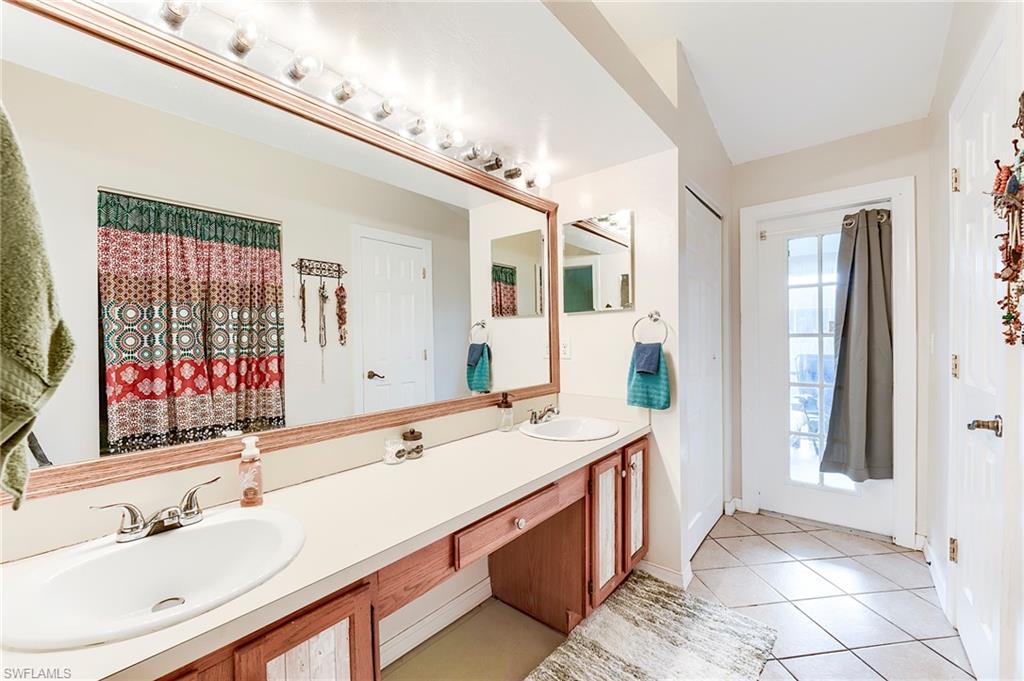 18257 Huckleberry Road Fort Myers, FL 33967 - Photo 10 of 18 a spacious bathroom with a sink double vanity and a mirror