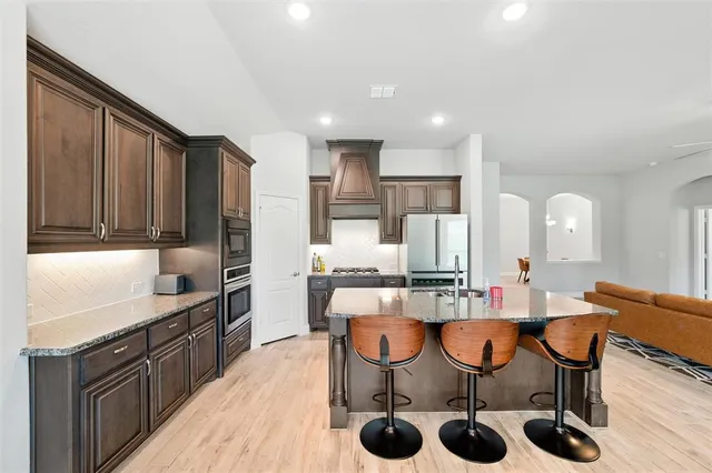 a large kitchen with a table and chairs