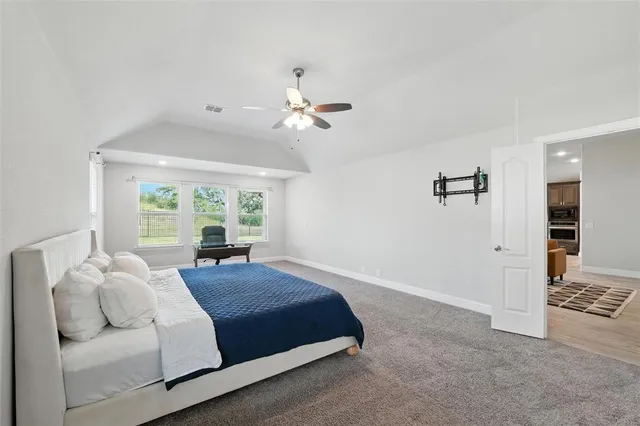 a living room with stainless steel appliances furniture a refrigerator and a kitchen view