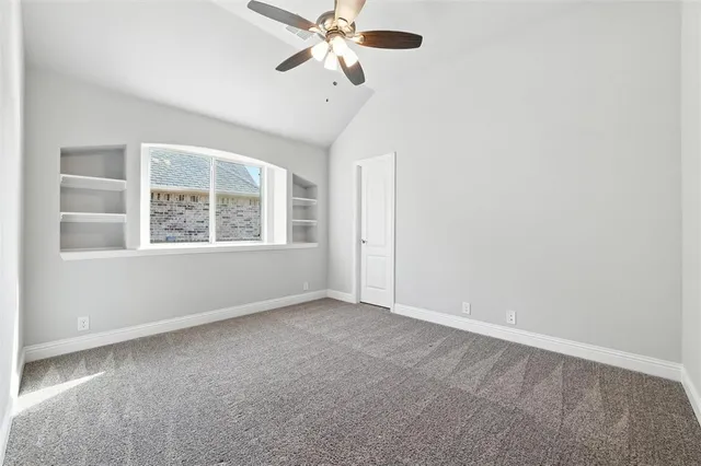 a view of room with window and ceiling fan