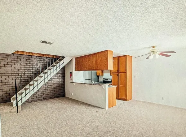 a view of a kitchen with wooden floor and stairs