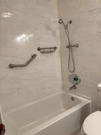 a bathroom with a bath tub with a shower