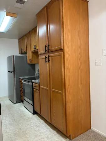 a kitchen with cabinets and stainless steel appliances