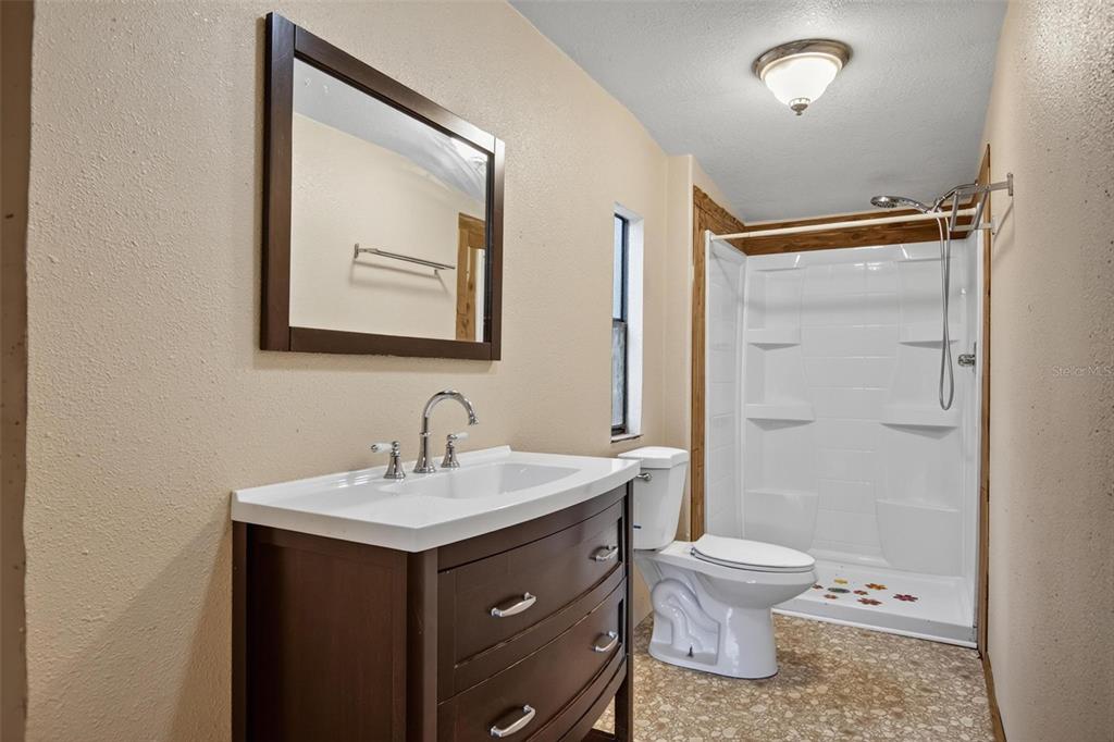 156 Kingfish Road Pomona Park, FL 32181 - Photo 22 of 55 a bathroom with a sink toilet and shower