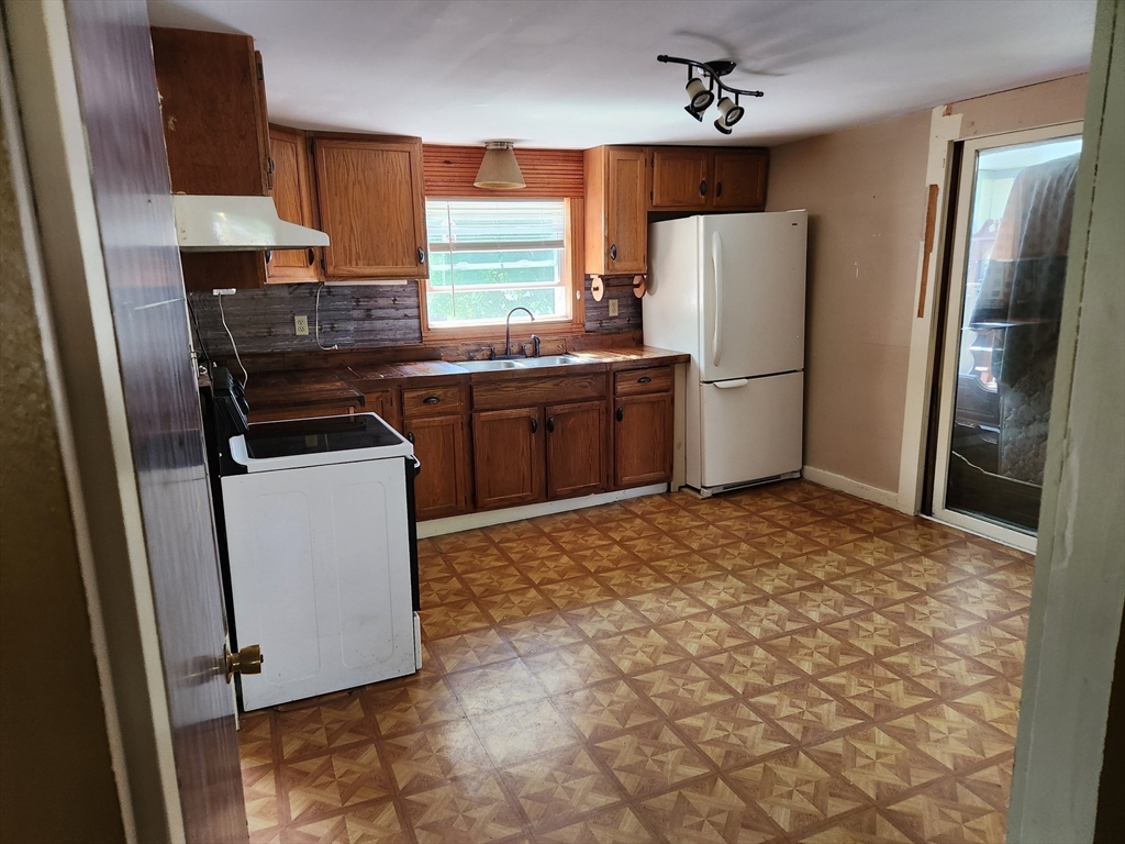 47 Beech Street Winchendon, MA 01475 - Photo 6 of 17 a kitchen with a refrigerator sink and stove