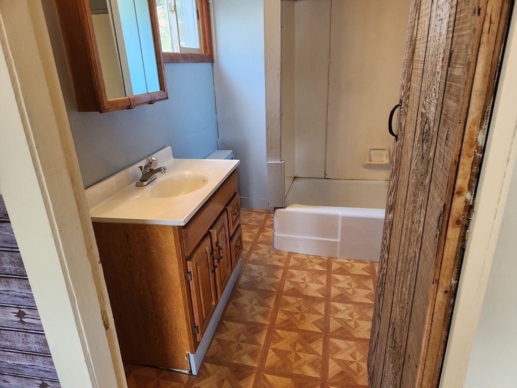 47 Beech Street Winchendon, MA 01475 - Photo 10 of 17 a bathroom with a sink a toilet a mirror and shower