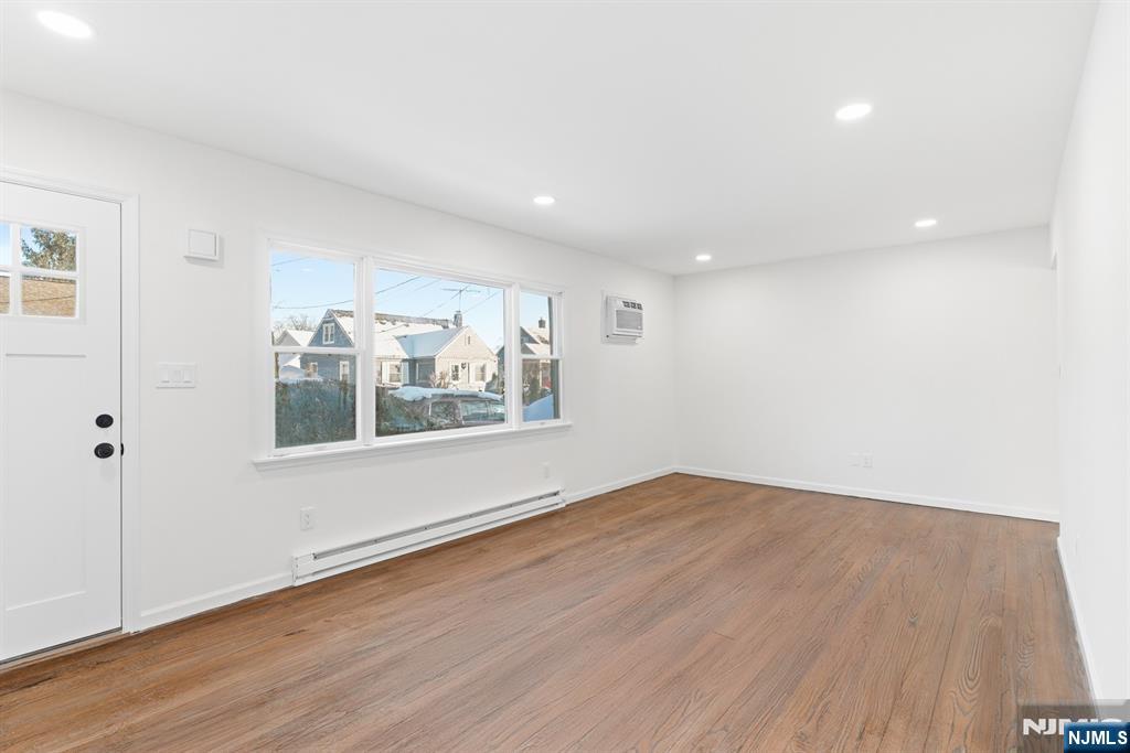 751 Hanson Avenue Perth Amboy, NJ 08861 - Photo 13 of 25 a view of an empty room with wooden floor and a window