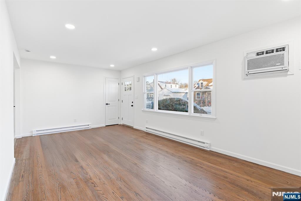 751 Hanson Avenue Perth Amboy, NJ 08861 - Photo 14 of 25 an empty room with wooden floor and windows