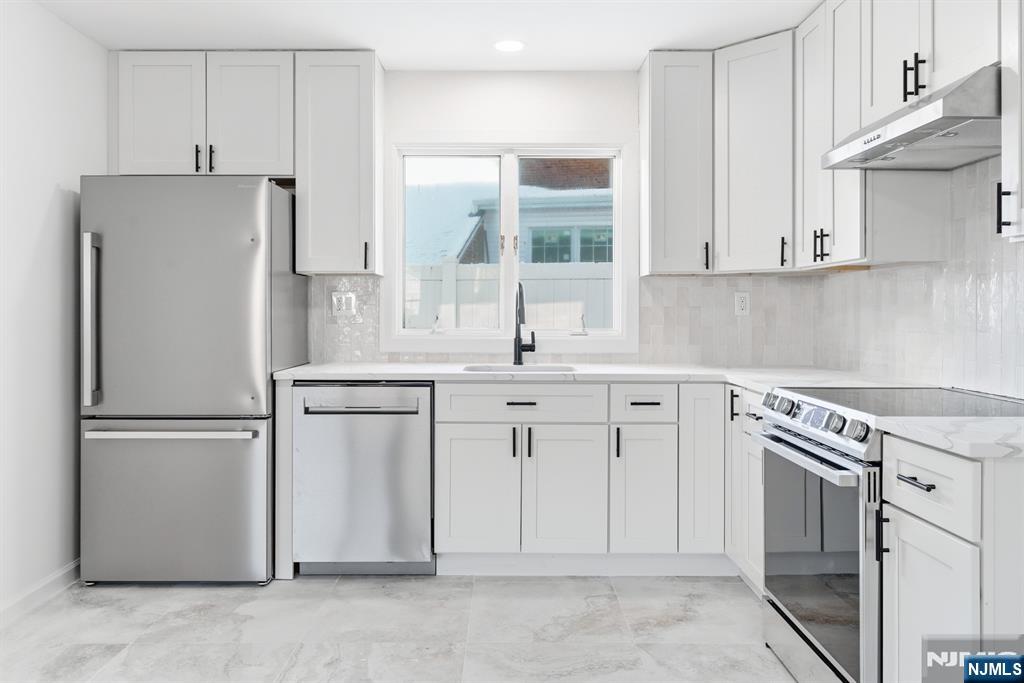 751 Hanson Avenue Perth Amboy, NJ 08861 - Photo 16 of 25 a kitchen with white cabinets and white appliances