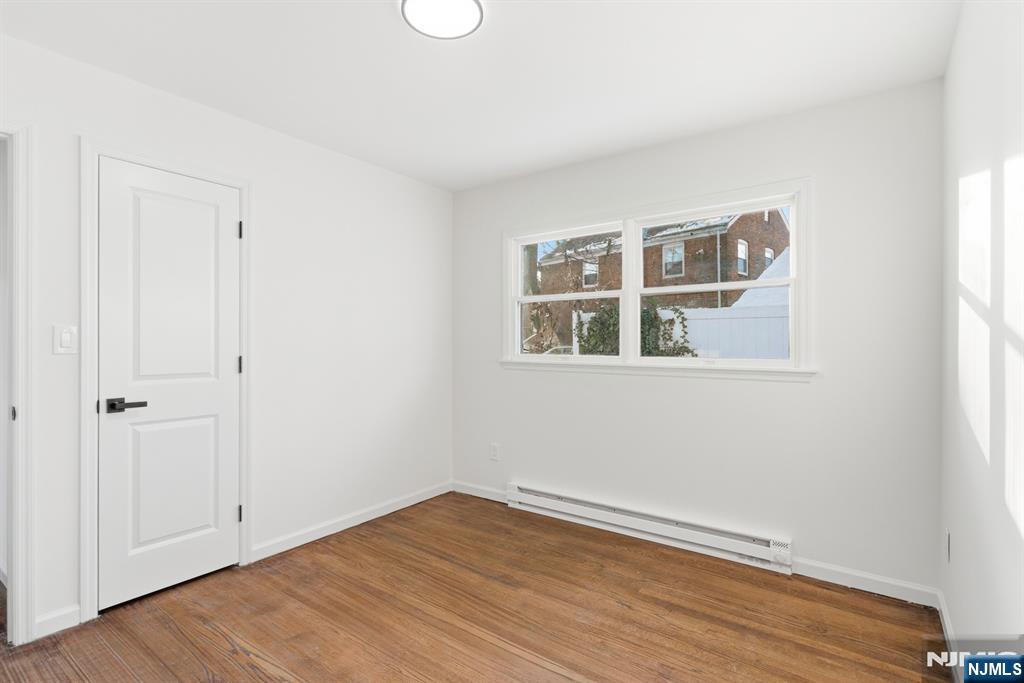 751 Hanson Avenue Perth Amboy, NJ 08861 - Photo 17 of 25 a view of empty room with wooden floor and fan