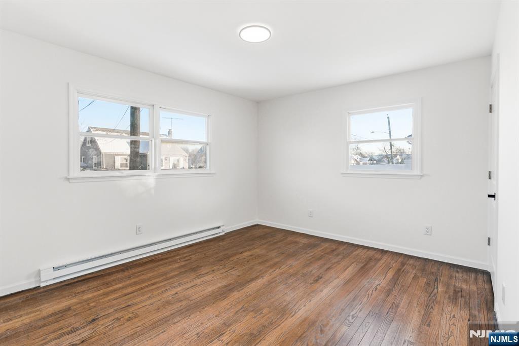 751 Hanson Avenue Perth Amboy, NJ 08861 - Photo 20 of 25 an empty room with wooden floor and windows