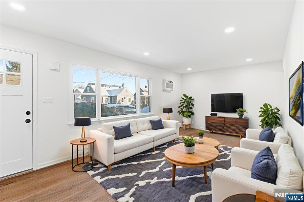 751 Hanson Avenue Perth Amboy, NJ 08861 - Photo 2 of 25 a living room with furniture and a flat screen tv
