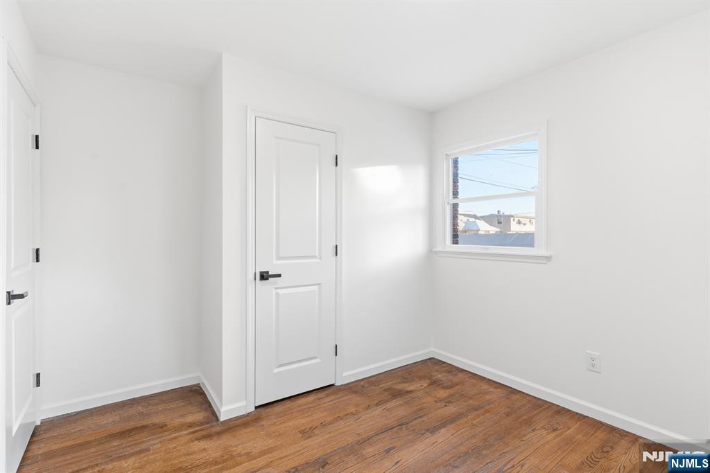 751 Hanson Avenue Perth Amboy, NJ 08861 - Photo 22 of 25 a view of a small space with wooden floor and a window