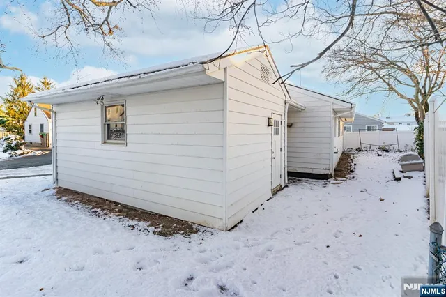 a view of a house with a snow in the yard