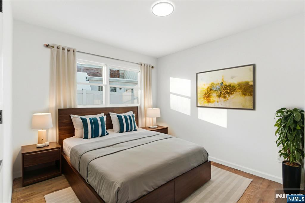 751 Hanson Avenue Perth Amboy, NJ 08861 - Photo 5 of 25 a bedroom with a bed and a potted plant