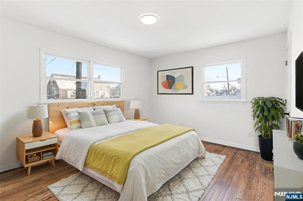 751 Hanson Avenue Perth Amboy, NJ 08861 - Photo 6 of 25 a bedroom with a bed and a painting on the wall