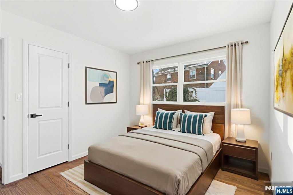 751 Hanson Avenue Perth Amboy, NJ 08861 - Photo 8 of 25 a bedroom with a bed and wooden floor