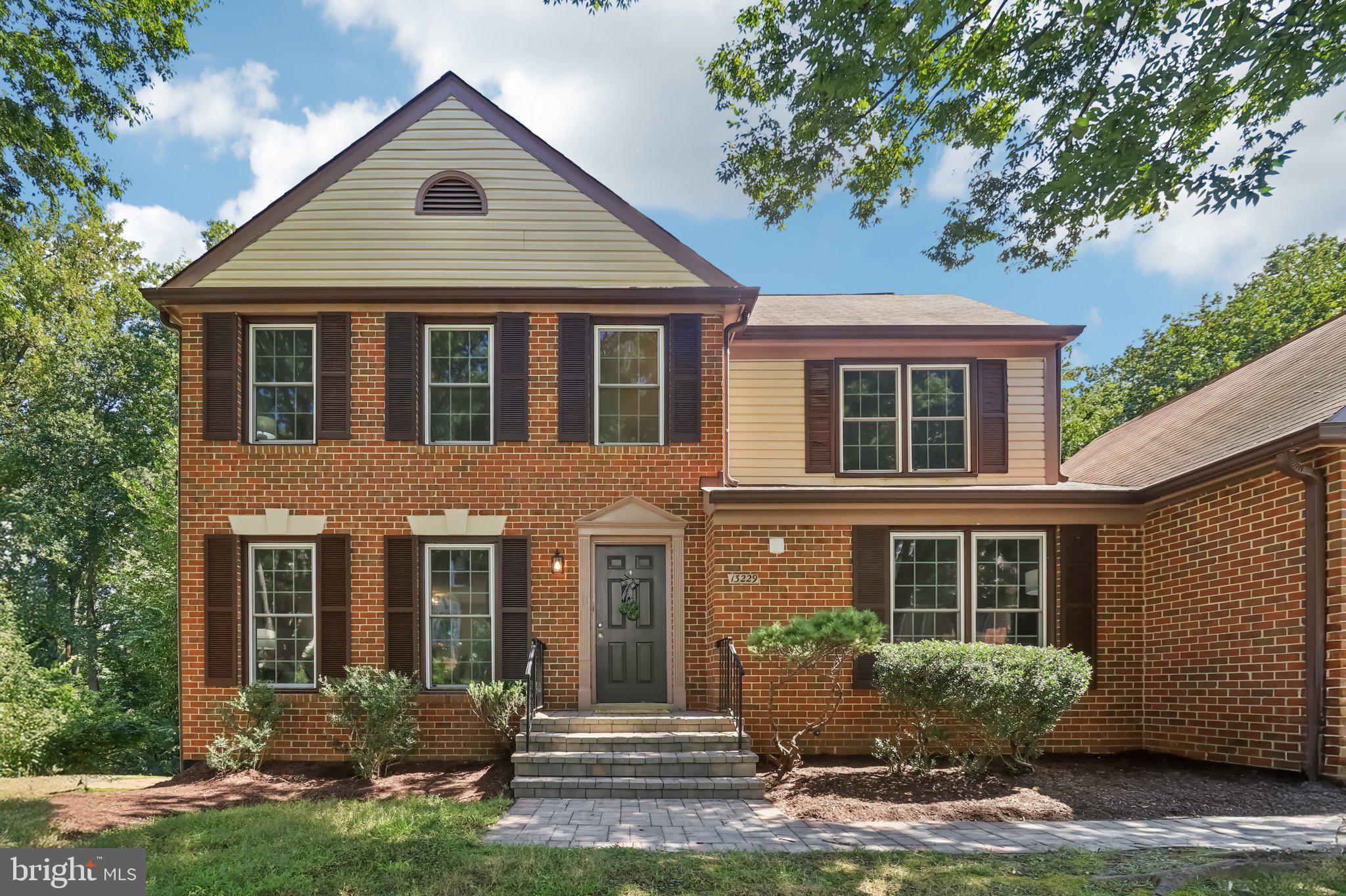 13229 Osterport Drive Silver Spring, MD 20906 - Photo 1 of 40 a front view of a house with yard and green space