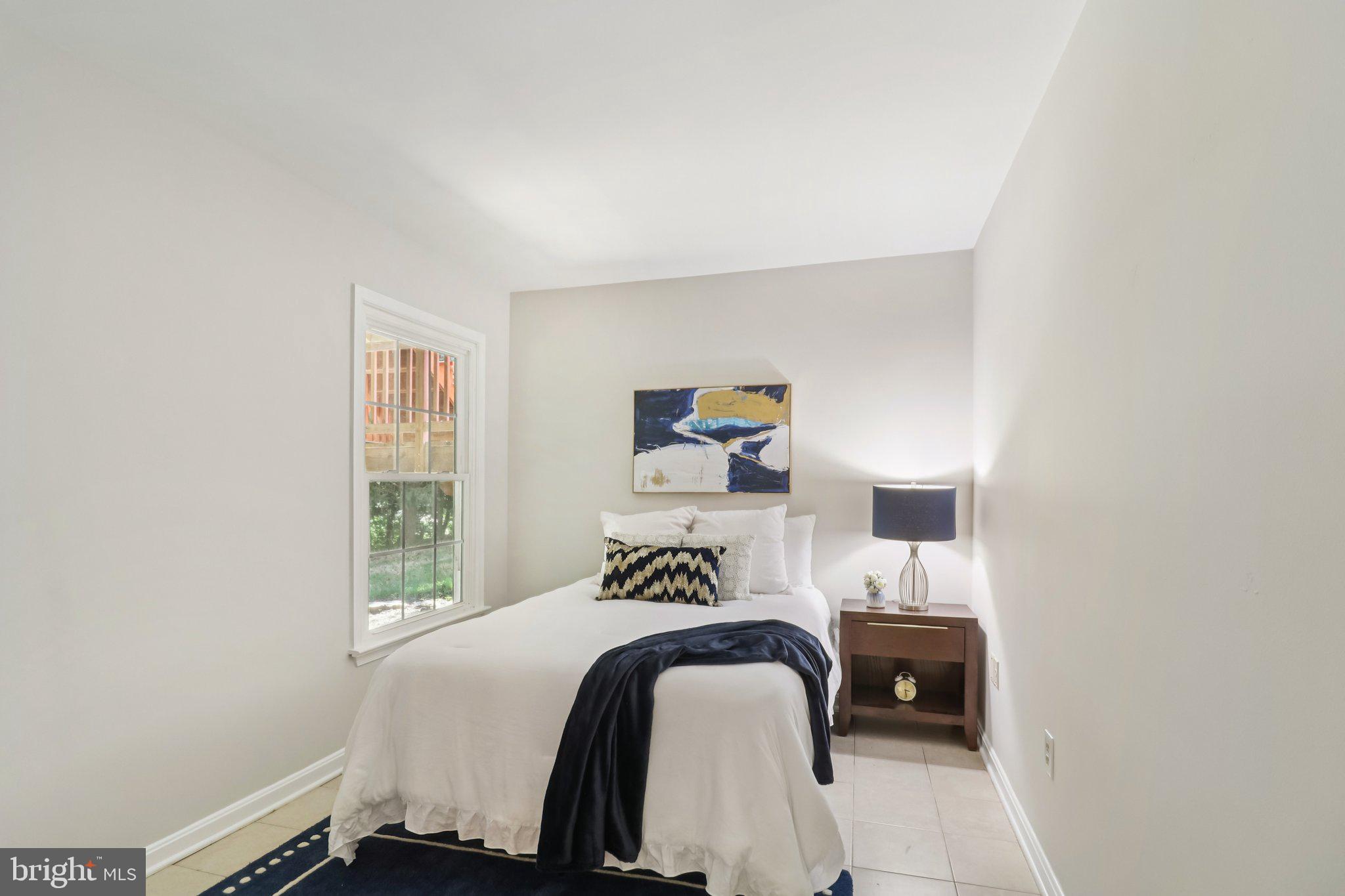 13229 Osterport Drive Silver Spring, MD 20906 - Photo 14 of 40 a bedroom with a bed and a window