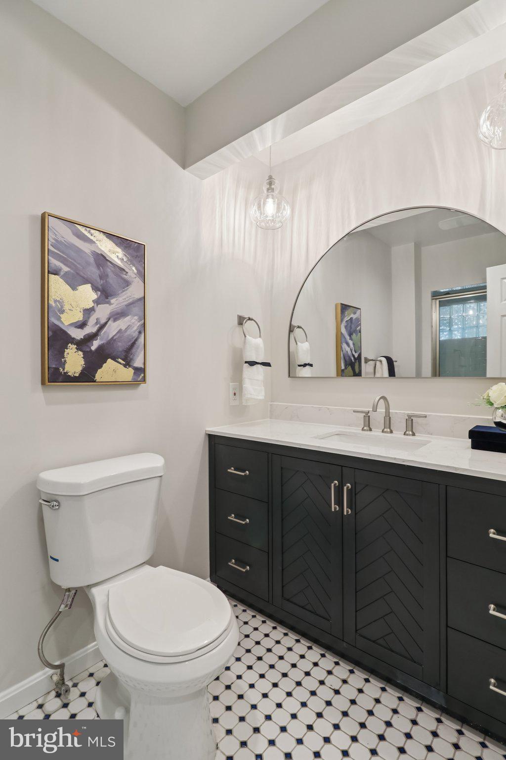 13229 Osterport Drive Silver Spring, MD 20906 - Photo 15 of 40 a bathroom with a toilet a sink and mirror