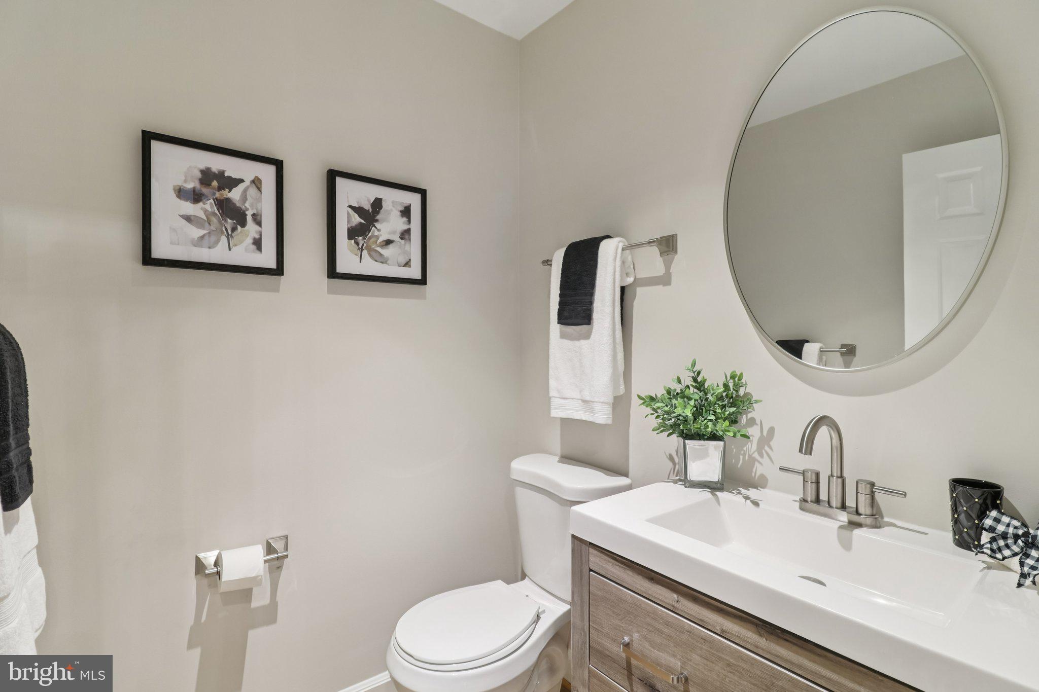 13229 Osterport Drive Silver Spring, MD 20906 - Photo 18 of 40 a bathroom with a toilet a sink and mirror