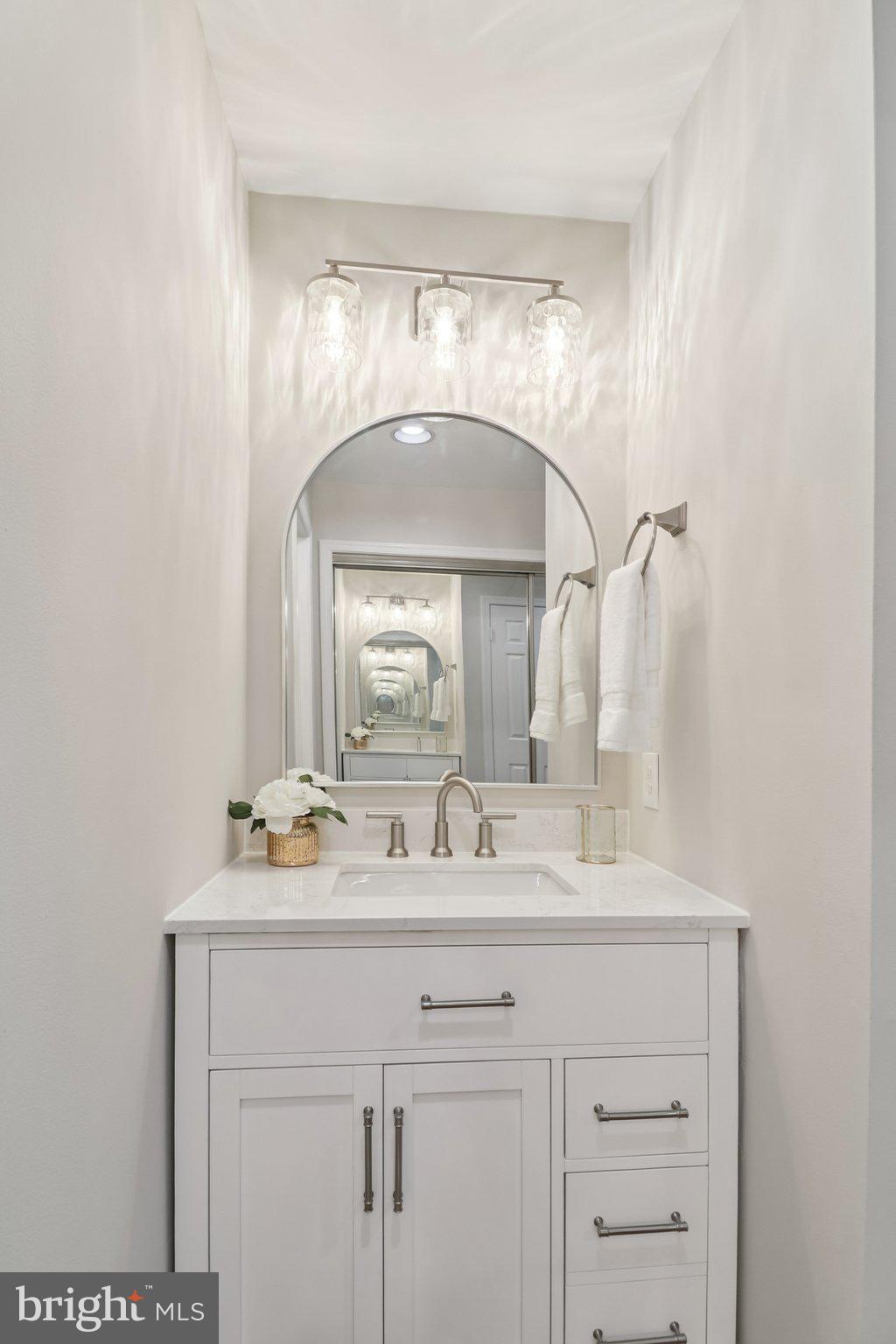 13229 Osterport Drive Silver Spring, MD 20906 - Photo 24 of 40 a bathroom with a sink and a mirror