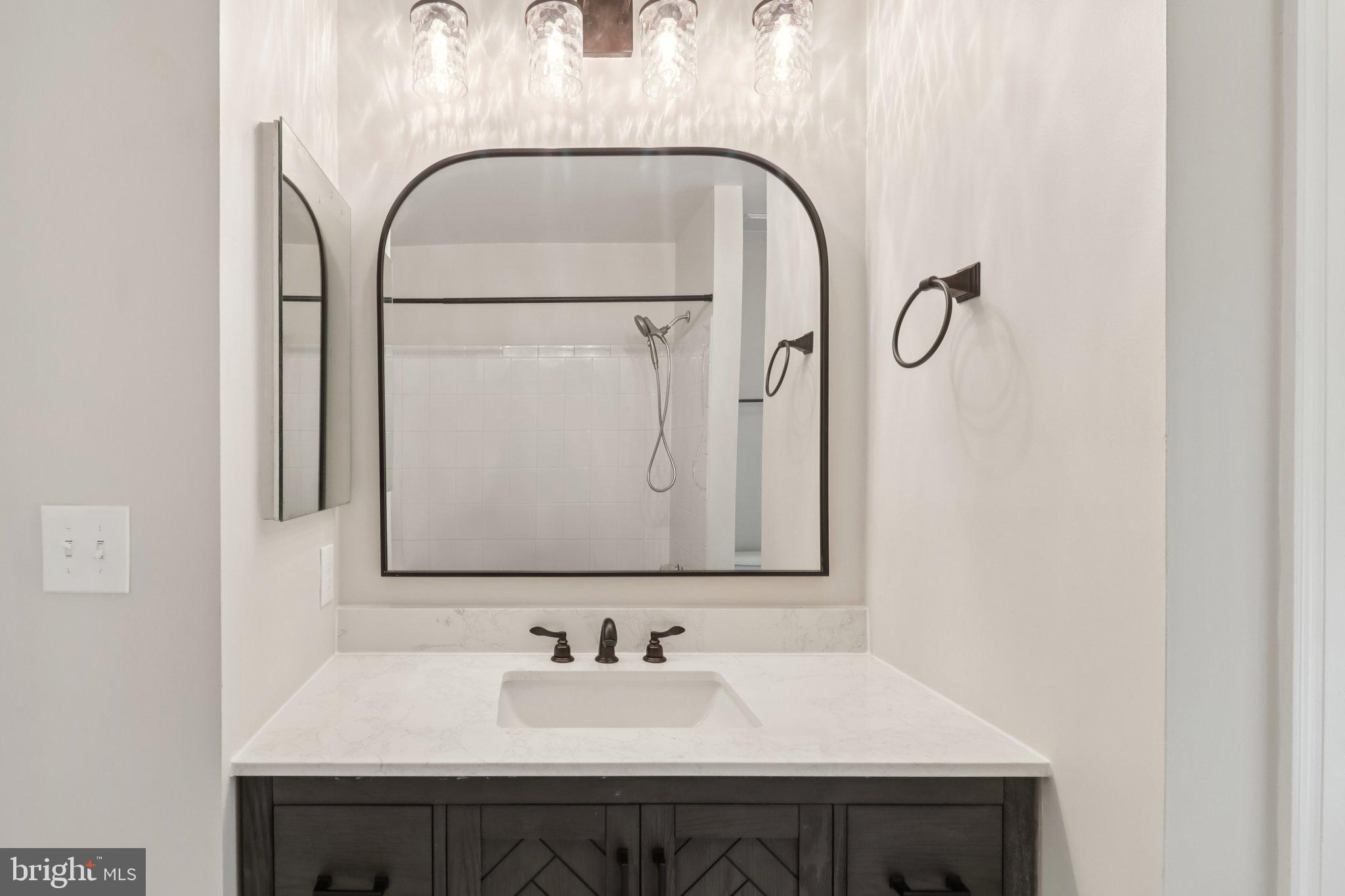 13229 Osterport Drive Silver Spring, MD 20906 - Photo 29 of 40 a bathroom with a sink and a mirror
