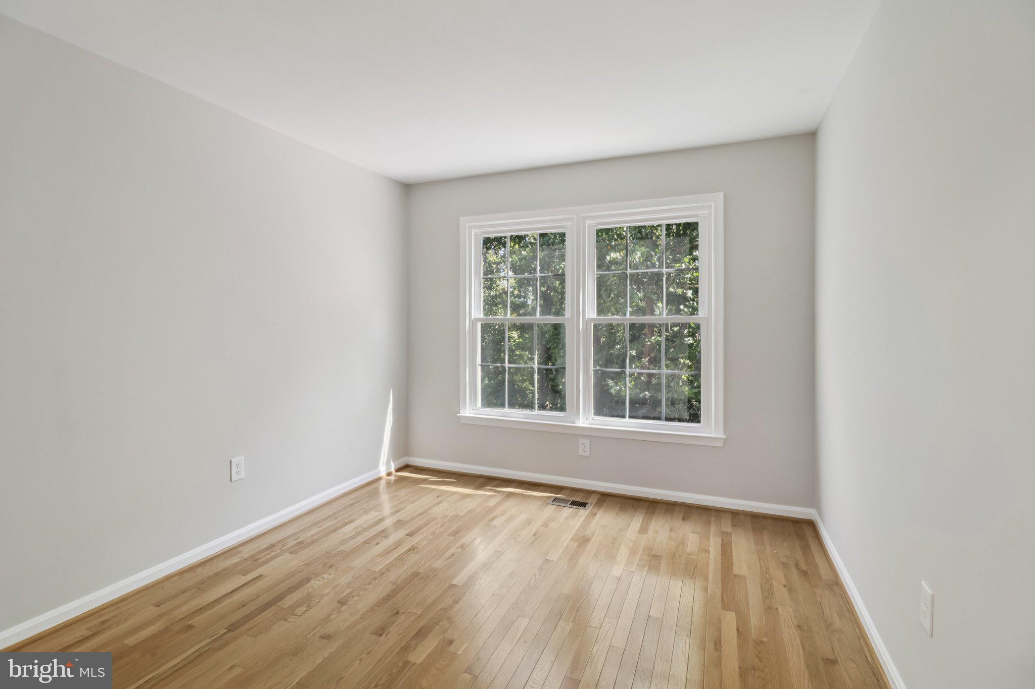 13229 Osterport Drive Silver Spring, MD 20906 - Photo 33 of 40 an empty room with wooden floor and windows