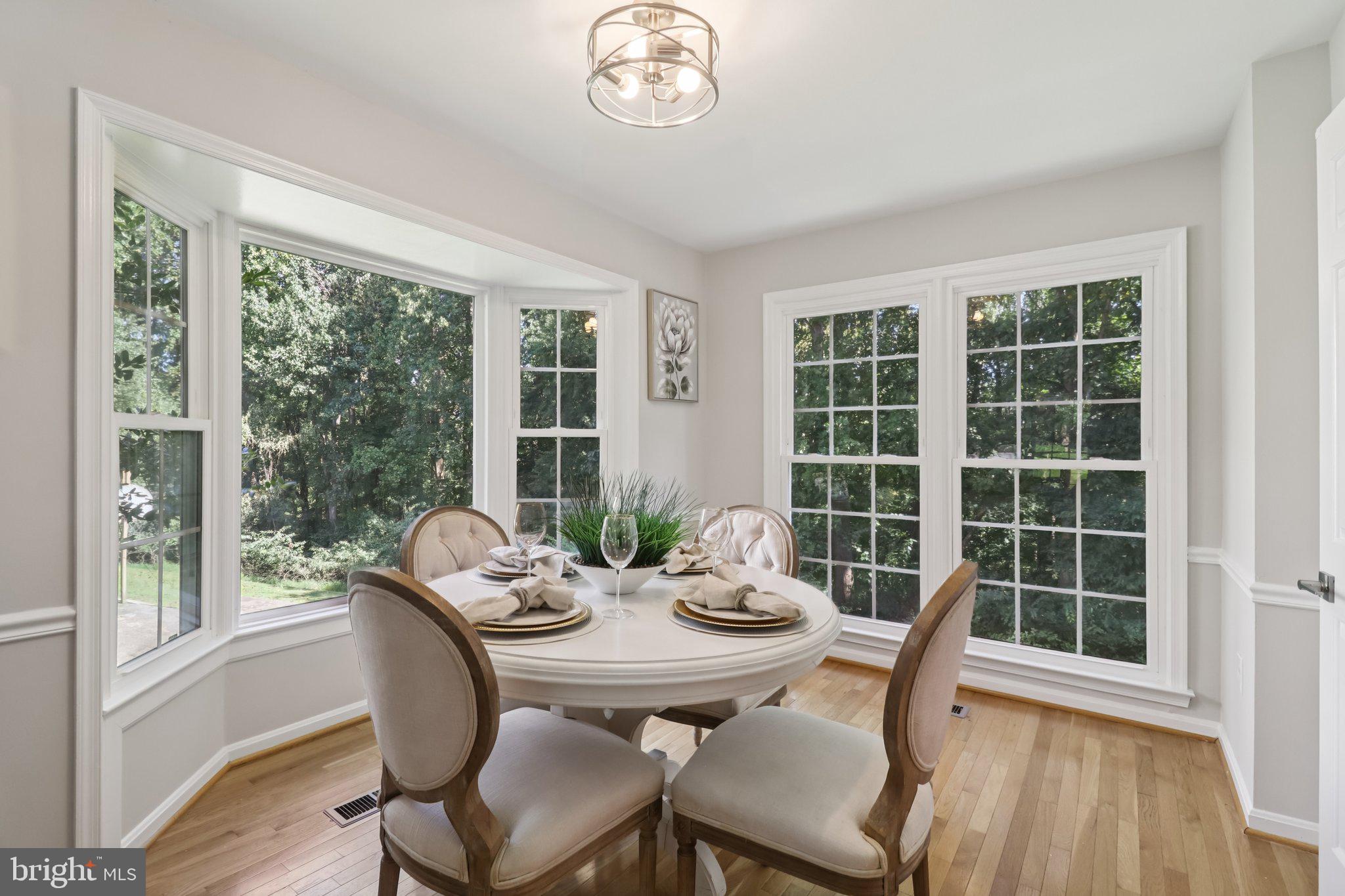 13229 Osterport Drive Silver Spring, MD 20906 - Photo 9 of 40 a view of a dining room with furniture window and wooden floor