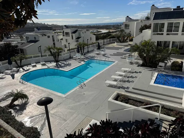 a view of a swimming pool with an outdoor seating