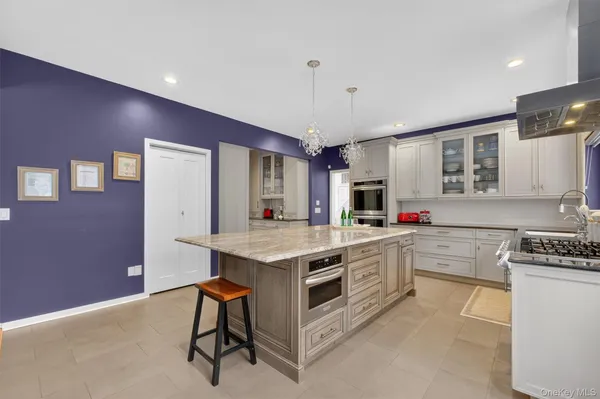 a kitchen with a sink cabinets and wooden floor