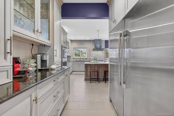 a kitchen with refrigerator and cabinets