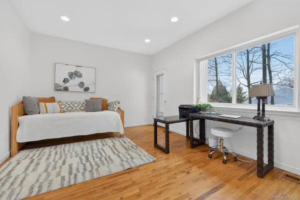 a bedroom with furniture and a wooden floor