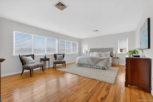 a bedroom with furniture and a wooden floor