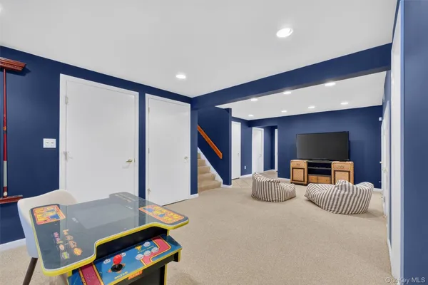 a room with a bed and a dresser with rug