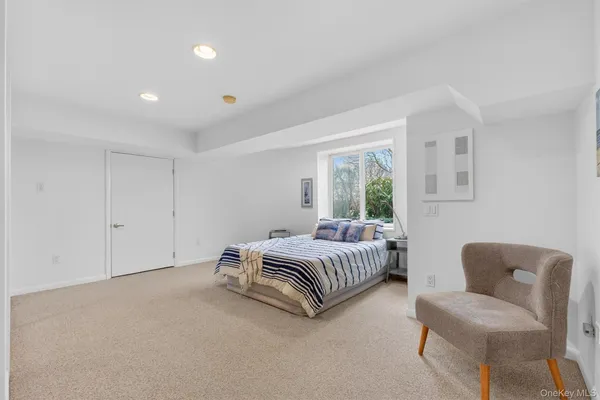 a spacious bedroom with a bed and a couch