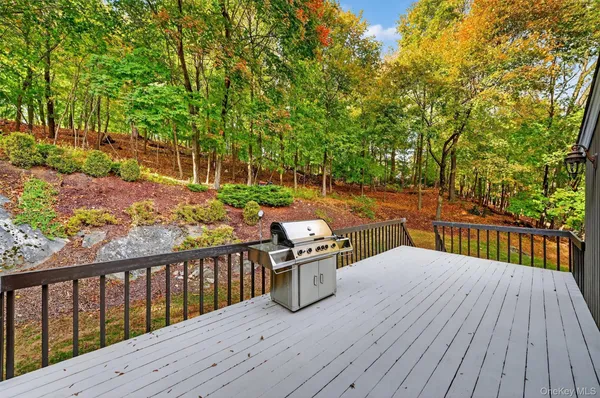 a view of a balcony with wooden floor and fence
