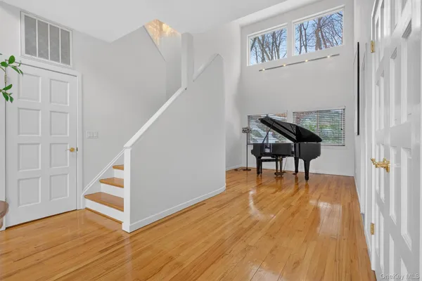 a view of entryway with wooden floor and stairs