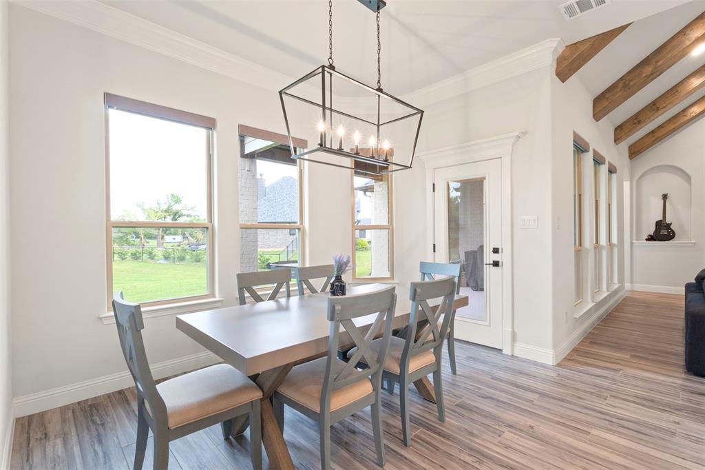 105 Clayton Crossing Springtown, TX 76082 - Photo 11 of 40 a view of a dining room with furniture window and wooden floor