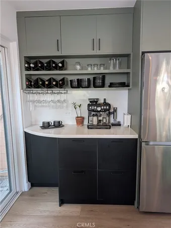 a kitchen with stainless steel appliances granite countertop a refrigerator and a stove